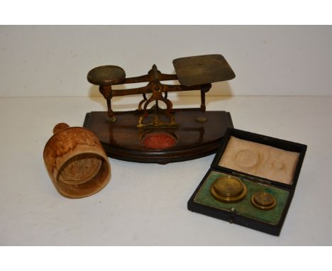 A pair of domestic postal scales, a set of stacking brass weights in case and a small wooden butter mould carved with a swan