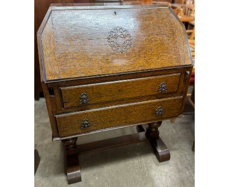 An Art Deco carved oak bureau 