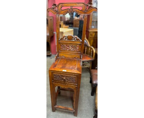 A Chinese carved hardwood mirror-back hallstand 