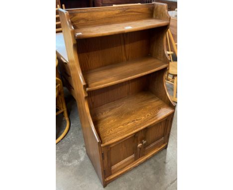 An Ercol Golden Dawn elm bookcase 