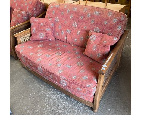 An Ercol ash bergere and fabric upholstered two seater settee 