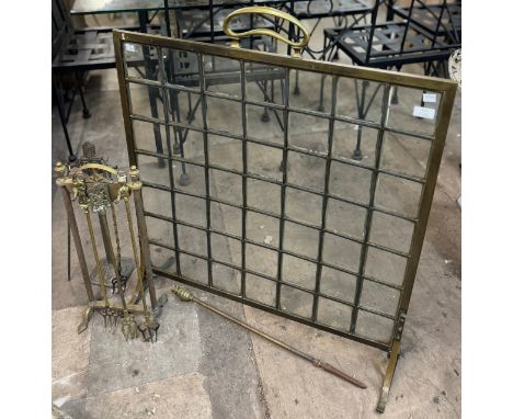 An Arts &amp; Crafts brass and glass panelled fire screen and two companion sets 