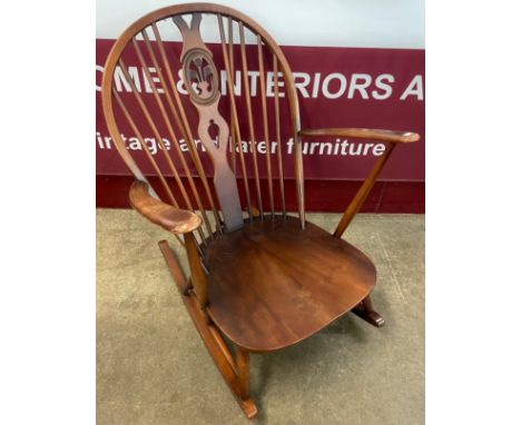 An Ercol Golden Dawn elm and beech fleur de lys rocking chair 