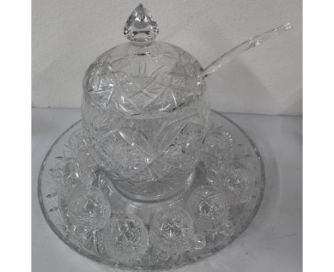 Cut glass punch bowl with ladle and eleven single handled matching glasses on cut glass tray. Punch bowl 20cm dia 39cm tall (