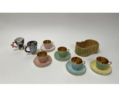 A collection of Crown Devon mixed pastel enamel and lustre teacups and saucers with scallop rim (marked verso), together with