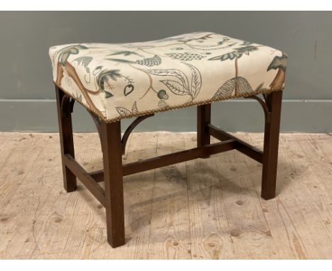A Victorian mahogany framed footstool, the top upholstered in a natural-coloured fabric with green floral motif, raised on sq