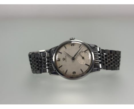 A 1960s Omega stainless steel manual wind wrist watch with silver dial and subsidiary seconds dial complication arabic numera