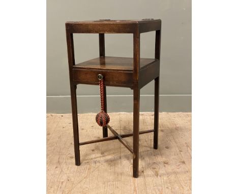 A Georgian mahogany washstand, with aperture for basin, above a central drawer and raised on square supports and a cross stre