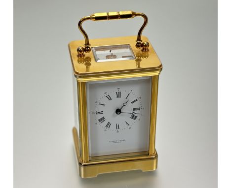 A Modern Anglus Hamilton &amp; Inches Edinburgh brass four-glass table clock with white enamel dial and roman numerals comple