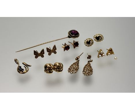 A collection of gold and yellow metal jewelry to include a pair of 9ct gold butterfly stud earrings, a pair of 9ct gold oval 