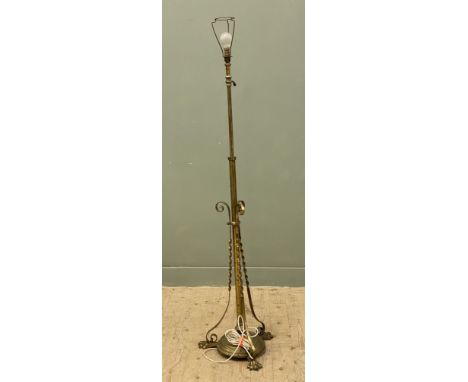An Edwardian brass floor-standing standard lamp, with adjustable height, with spiral decoration to supports and paw feet: h.x