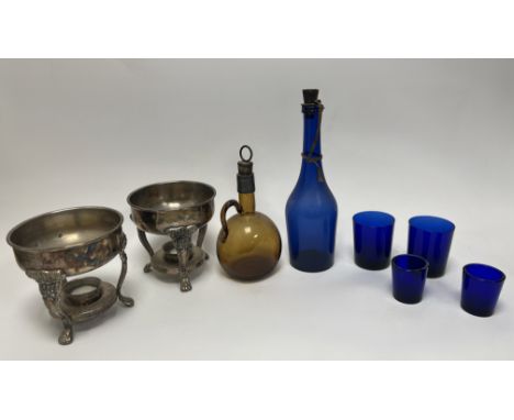 A set of two short blue glasses, together with a set of two cobalt blue glass tumblers, a large blue glass wine bottle with a