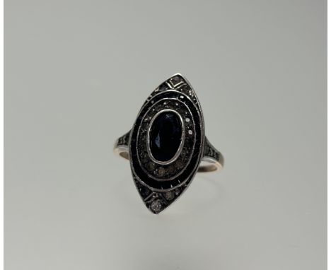 A 1930s Art Deco yellow and white metal navette-shaped cocktail ring set French jet central stone within bands of paste and F