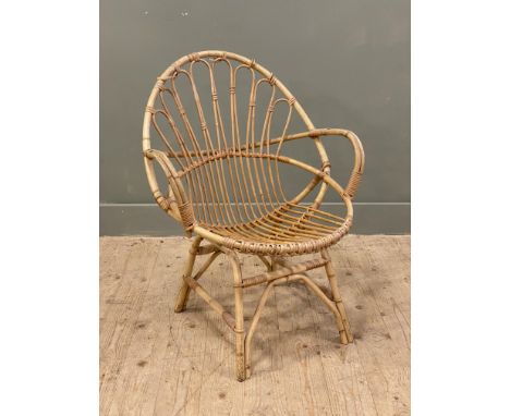 A mid-century bamboo and cane armchair, the shaped back with arched details, raised on splayed feet: h.x 82cm l.x 63cm w.x 60