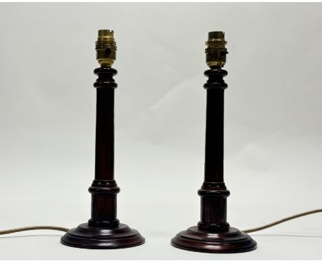 A pair of wooden stained candlestick style table lamps. (h-31.5cm) (2)