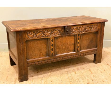 A late 17th/ early 18th century oak coffer chest (with 20th century additions), with leaf foliate carving to frieze and tripl