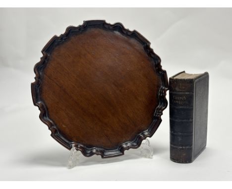 A 1920's mahogany carved waiter with pie crust border with split. (30cmx30cm) together with a Church Services Book - The Book