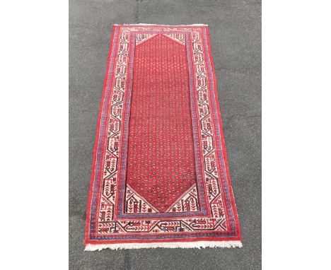An Iranian Shirvan style corridor runner rug, with allover boath design, enclosed within a stylized leaf scrolling border, on