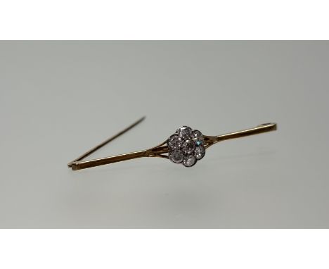 A 9ct gold bar brooch set with old mine cut diamond central cluster, center stone approximately 0,25ct within a surround of s