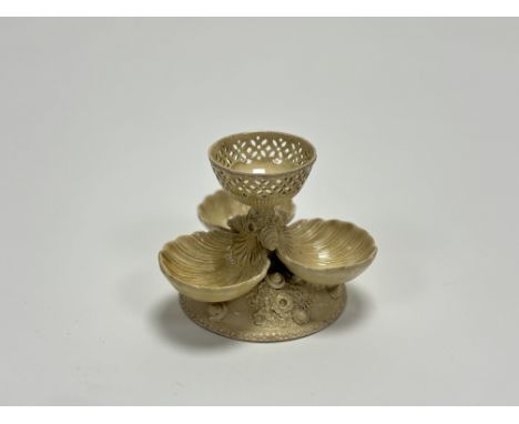 A Creamware sweetmeat dish, with three shell moulded dishes with pierced bowl to centre, raised on a circuar base deocrated w