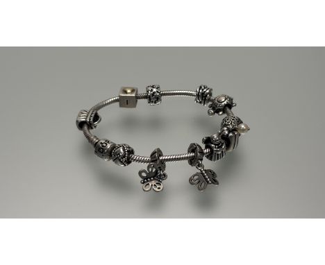 A Pandora silver charm bracelet with ten various beads: d. x 7cm 48.8g 