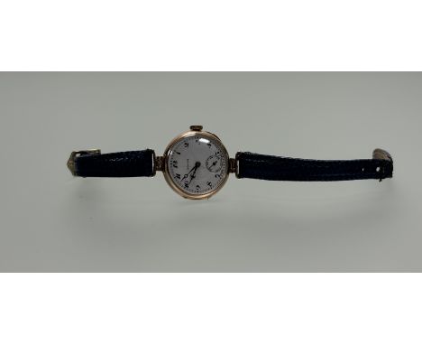 A vintage 9ct gold Rolex manual wind wristwatch with white enamel dial and arabic numerals and seconds dial complication on l