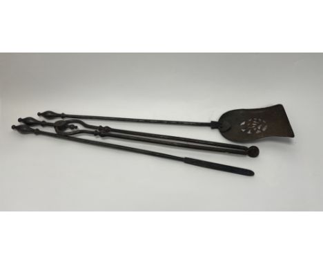 A wrought iron fireside companion set comprising a shovel, poker and tongs (shovel l. 77cm) 