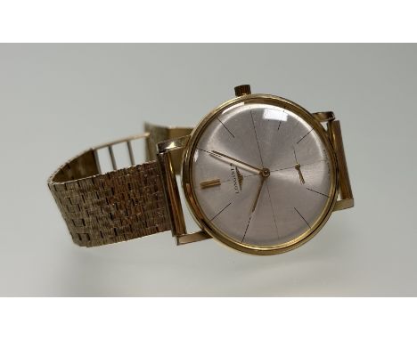A vintage Longines gilt metal manual wind wristwatch with silvered dial and baton hour markers and seconds complication on 9c