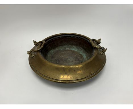 An Eastern brass twin handled cooking pot (d. 40cm) 
