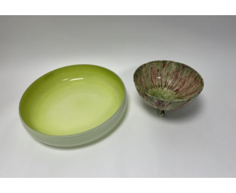 A 1920s pottery dish raised on three moulded supports and decorated with green and red drip glaze (h. 14cm), together with a 