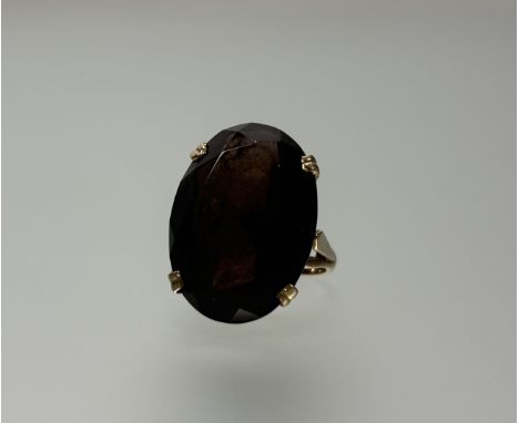 A 9ct gold cocktail style ring set oval faceted cairngorm: l x 2.5cm w. x 2cm mounted in four claw setting N 10.5g 