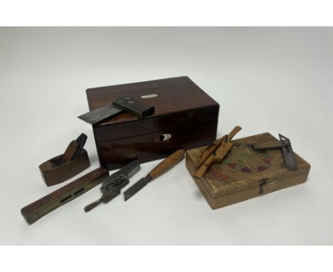 A mahogany box with Mother of Pearl inlay and complete with floral paper lining, together with small woodworking tools, plane