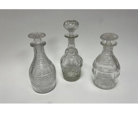 A collection of three 19thc cut crystal decanters comprising, one with a step cut neck above small diamond cut diagonals comp