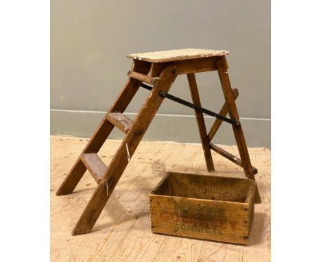 A pine Isle 'o' Sun Guernsey Tomatoes box, alongside a distressed foldable three-step ladder: h.x 50cm
