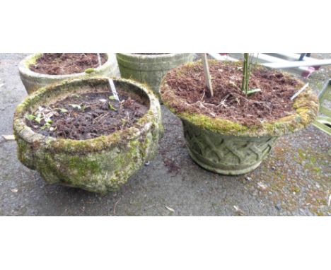 A 46cm diameter concrete planter with moulded decoration - sold with another