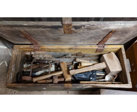 A wooden toolbox containing a quantity of assorted tools