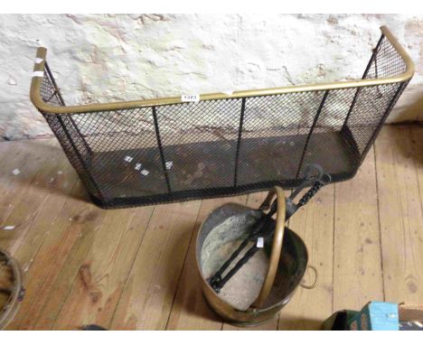 An old brass and mesh fire fender - sold with a brass coal scuttle of helmet form and two wrought iron fire irons