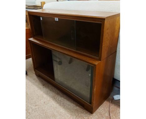 An 89cm vintage Minty two part modular bookcase with glass sliding doors and original label