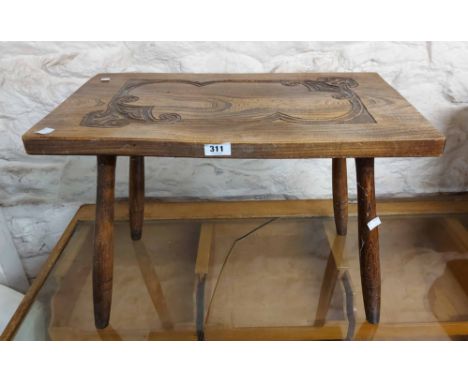 A 60cm vintage mixed wood stool with carved decoration to the solid elm seat