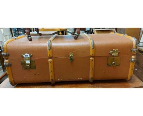 A 91cm vintage cane bound travelling trunk with flanking leather strap handles