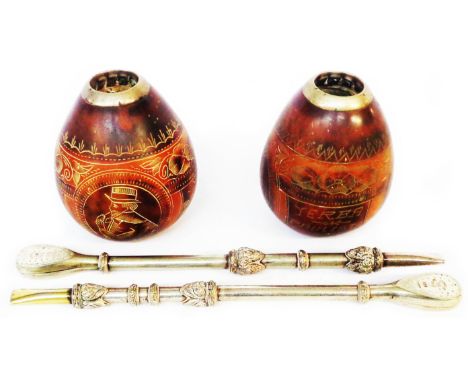 A four piece Yerba mate set, comprising two marked 800 W. La Multa white metal bombilla straws - 'No. 27942' and two gourd dr