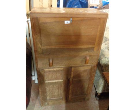 A 60cm vintage quarter sawn oak bureau with pigeon-hole fitted interior and double panelled cupboard under, set on plinth bas