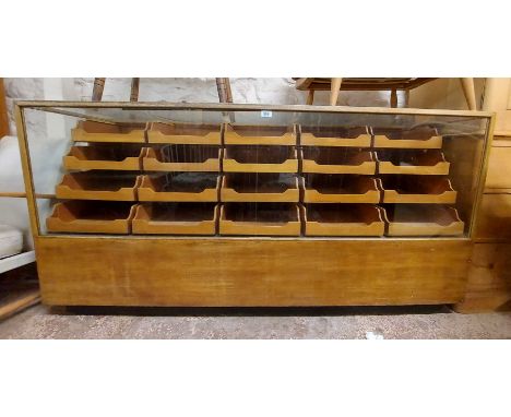 A 1.8m vintage mixed wood haberdashery unit with glazed front and top (a/f) and an array of drawers - bearing plaque for Clem