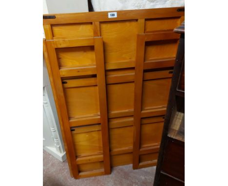 A modern mixed wood three shelf folding bookcase