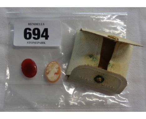 A small pouch containing a vintage miniature cameo depicting a classical lady and a plain red panel
