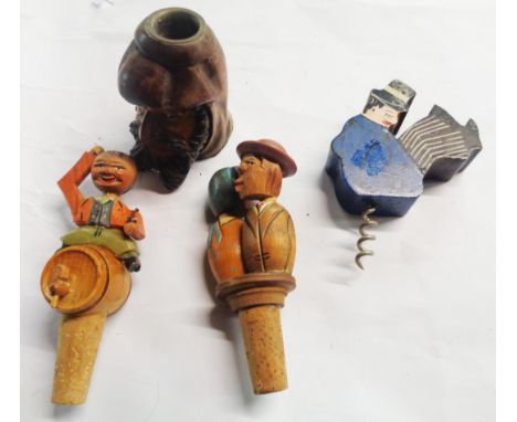 A bag containing a quantity of novelty items comprising a candlestick in the form of a man's head, two continental carved woo