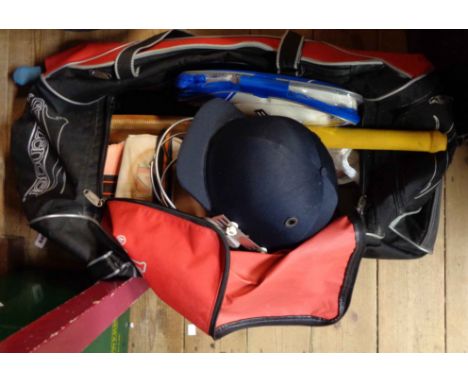 A Slazenger cricket bag containing a quantity of cricket equipment including Newbery and Gray bats, cricket balls, helmet, pa