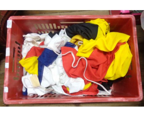 A crate containing a quantity of vintage flags