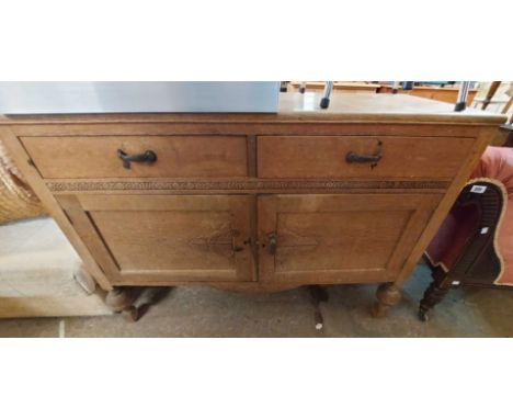 A 1.22m vintage light oak sideboard with two frieze drawers and double panelled cupboard under, set on bulbous turned front l