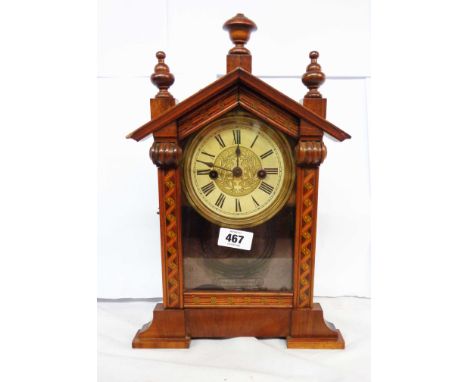 An antique small walnut cased American shelf clock with printed dial and simple German gong striking movement